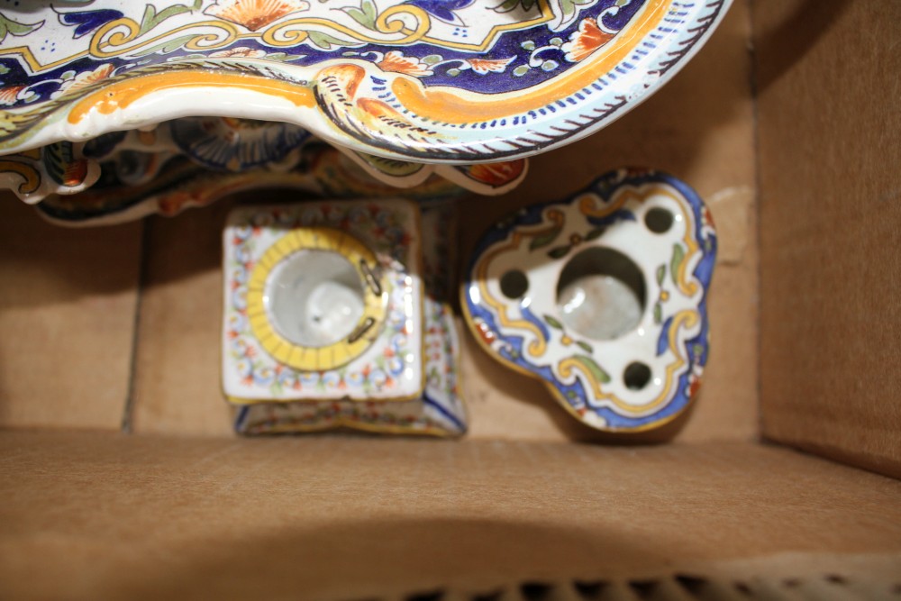A collection of five St Malo faience dishes, a similar chamberstick, two inkwells, an unsigned oil lamp and a Deruta casket